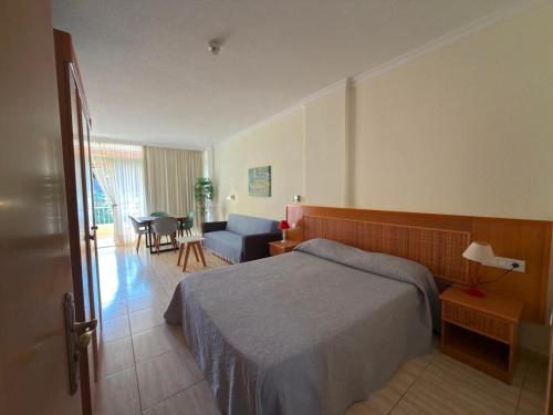 a bedroom with a bed and a living room at El Estudio de Johanna in Puerto de la Cruz