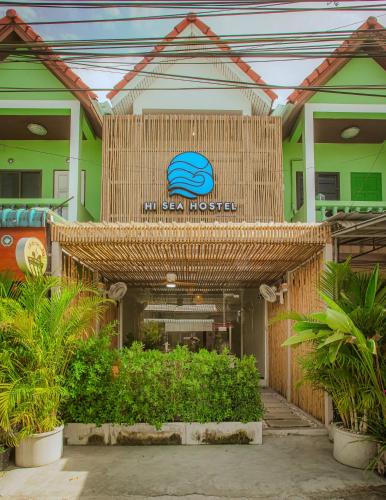 a building with a sign on the front of it at Hi Sea Hostel - Boutique Style in Center, 15 min Walk from Pier in Thong Sala