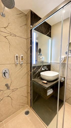 a bathroom with a sink and a mirror at Pride Hotel Bhopal in Bhopal