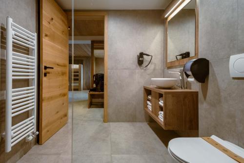 a bathroom with a sink and a mirror at Hotel Panorama Kope in Šmartno pri Slovenj Gradcu