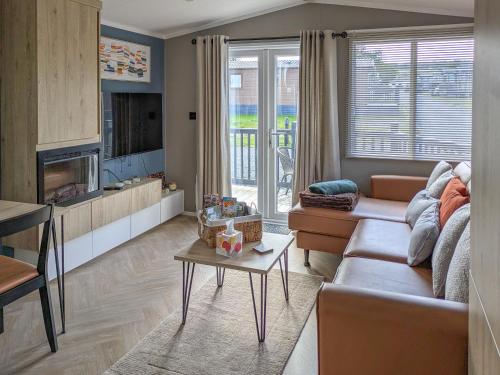 a living room with a couch and a table at Solo's in East Heslerton