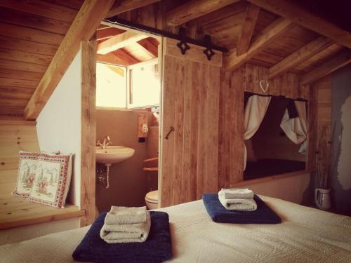 a bedroom with a bed and a sink in a room at B&B Baita Bertolini in Monclassico