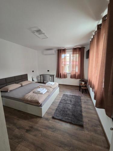 a bedroom with a bed and a table in it at The Cosy House in Kyustendil