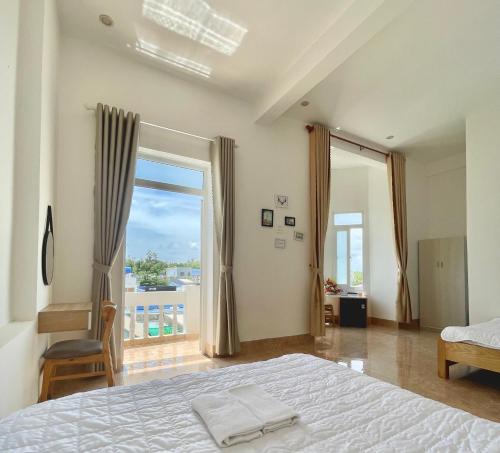 a bedroom with a bed and a large window at Thu Quy Hotel in Cu Lao Thu