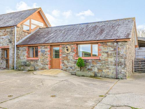 an old stone house with a garage at The Cartlinhay - Uk35756 in Bideford