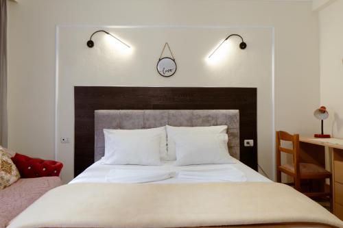 a bedroom with a large bed with two lights above it at Martin Villa 2 in Gjirokastër