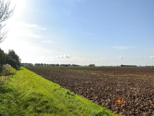 a plowed field with a dirt road in the foreground at Atmospheric in Patrington