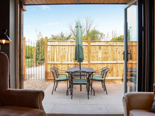 a patio with a table with chairs and an umbrella at The Watertower in Marlborough