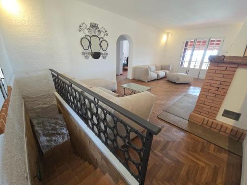 a living room with a staircase and a couch at Villa Timea Piscina e Tennis Vista Isole Egadi in Marsala