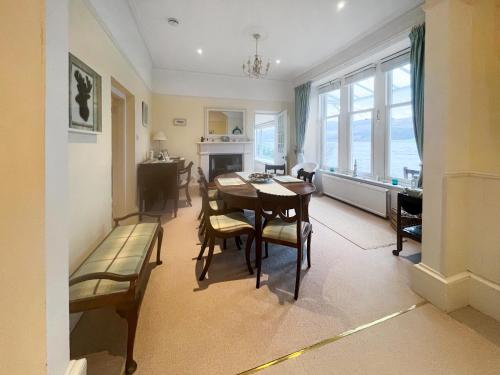 a kitchen and dining room with a table and chairs at Failte in Colintraive