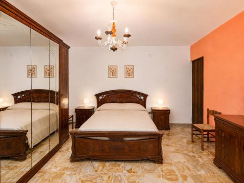 a bedroom with two beds and a chandelier at Terrazza sul Borgo in Camerota