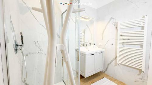 a white bathroom with a sink and a shower at Il Posto Perfetto, Terre Marine in Corvara