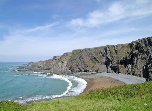 a view of a beach with a rocky cliff at Hawthorne in Woolfardisworthy
