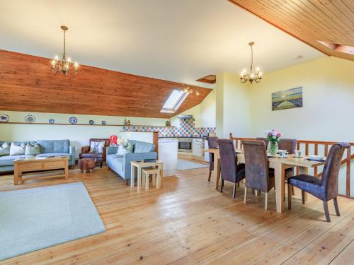 a living room with a couch and a table at The Granary - Uk35755 in Bideford