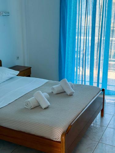 a bedroom with a bed with towels on it at Brother's House in Kallithea Halkidikis
