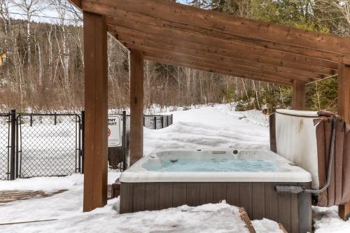 a hot tub in a gazebo in the snow at Private Pool - Spa - Pool Table - Le St-Come in Saint Come