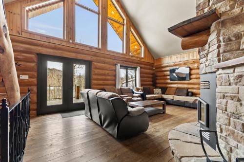a living room with wooden walls and a vaulted ceiling at Private Pool - Spa - Pool Table - Le St-Come in Saint Come
