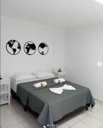 a room with a bed with two tables and two clocks at casa de esteban in Puerto Iguazú