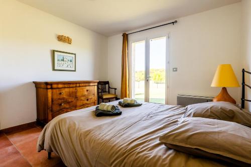 a bedroom with a large bed and a window at La Grange D'anthounin in Redortiers