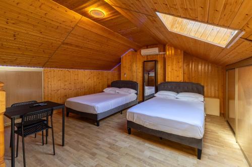 a bedroom with two beds and a table and a skylight at Semi-detached Hse in Loeches