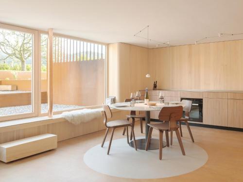 a kitchen and dining room with a table and chairs at Haus des Onkels in Hittisau