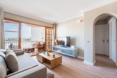 a living room with a couch and a tv at CARABELA 93 in Alcudia
