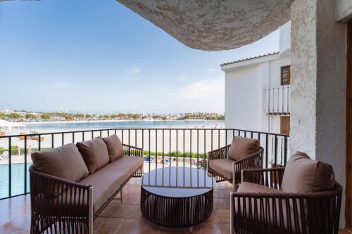 a balcony with couches and a view of the water at CARABELA 93 in Alcudia