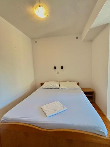 a bed in a small room with a blue mattress at Apartments Adriatic Nest in Omiš