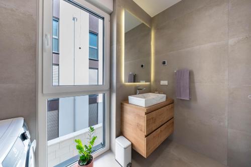a bathroom with a sink and a window at Premium Šimuni by Pag tours in Šimuni