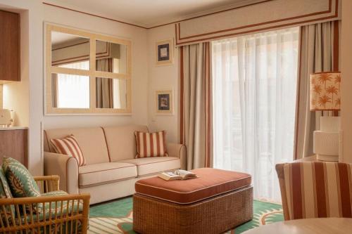 a living room with a couch and a table at Grande Real Santa Eulalia Resort & Hotel Spa in Albufeira