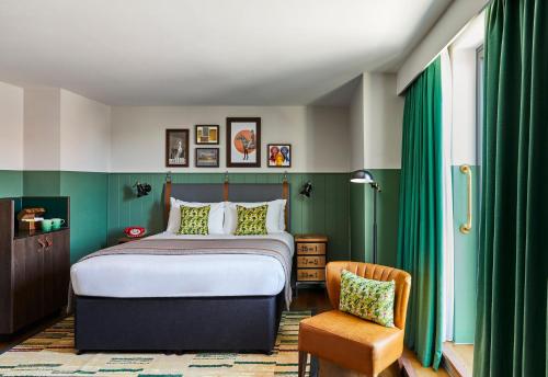 a bedroom with a bed and a chair at Hotel Indigo - Chester by IHG in Chester