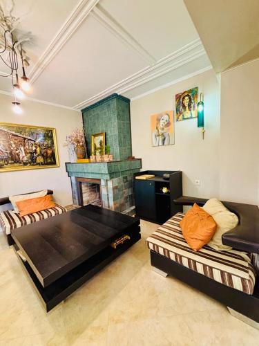 a living room with two beds and a fireplace at Shin Boutique Hotel with Mini Golf Terrace in Buriaki