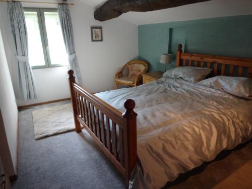 a bedroom with a large bed and a window at Bergerie L'Occitane in La Caunette
