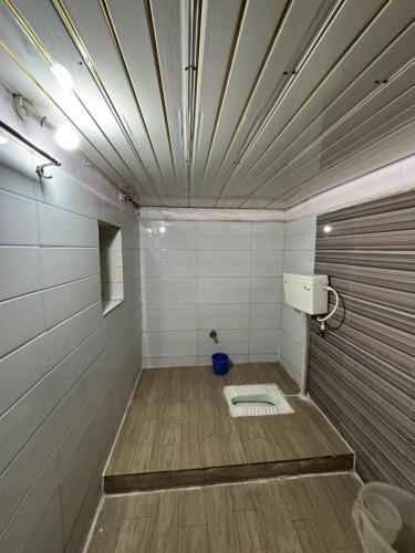 an empty bathroom with a toilet in a room at Hotel Shifa Manor in Chāībāsa
