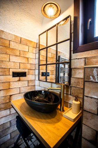 a bathroom with a black sink and a mirror at Galaxy6189 Guesthouse in Tapolca