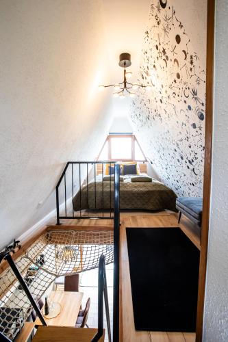 a room with a loft with a bed and a staircase at Galaxy6189 Guesthouse in Tapolca