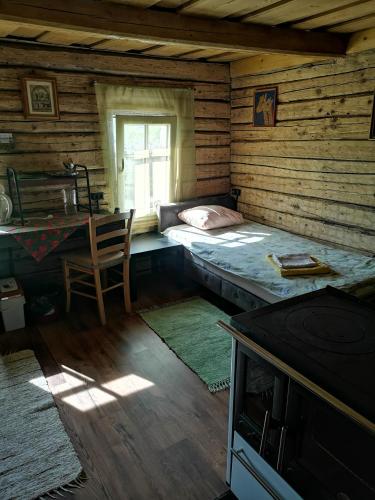 a room with a bed and a desk and a window at Köleri B&B in Suure-Jaani
