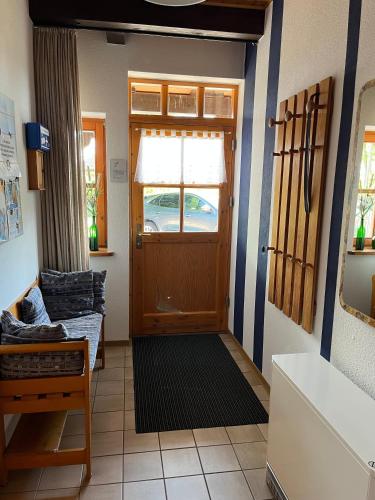 a living room with a door and a couch at Ferienwohnung Raschke in Fehmarnsund