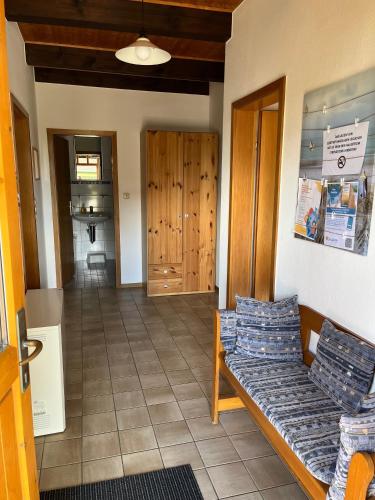 a living room with a couch and a hallway at Ferienwohnung Raschke in Fehmarnsund