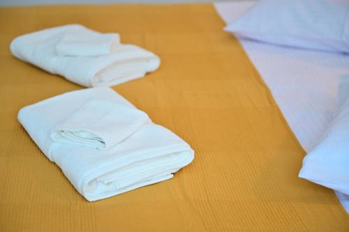 two white towels sitting on top of a table at FLH - Brukenthal Studios - Old Town in Sibiu