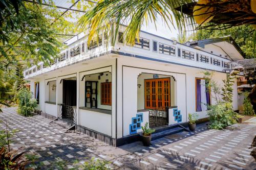 a house in the middle of a courtyard at TJ Signature Spaces in Point Pedro
