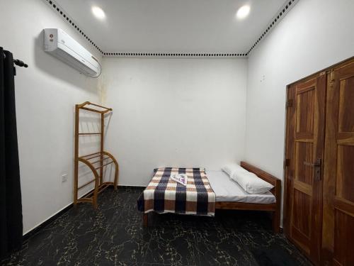 a small room with a bed and a ladder at TJ Signature Spaces in Point Pedro