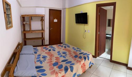 a bedroom with a bed and a television in it at RioVermelhopoint in Salvador
