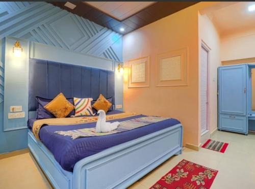 a bedroom with a bed with a swan on it at Hotel Amar in Mussoorie