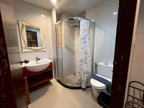 a bathroom with a shower and a toilet and a sink at The Pixel Sri Panwa, Phuket in Ban Ao Makham