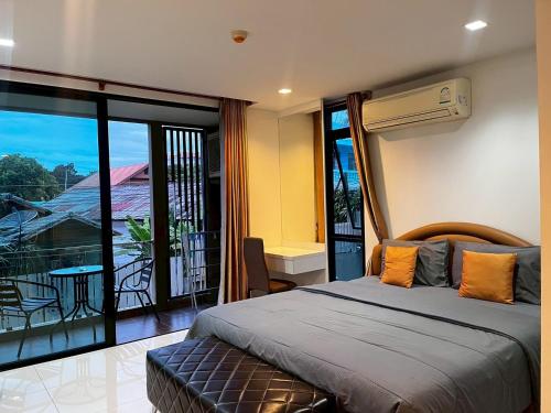 a bedroom with a bed and a balcony at The Pixel Sri Panwa, Phuket in Ban Ao Makham