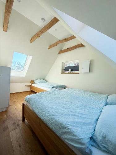 a bedroom with a bed with blue sheets and a window at FiO Ferienhäuser - Ferien in Ohne in Ohne