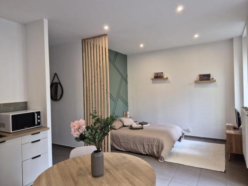 a bedroom with a bed and a table in it at La terrasse du palais in Metz