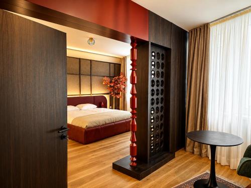 a bedroom with a bed and a table in a room at Design-Apartment Siegen Oberstadt in Siegen