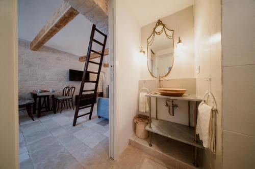 a bathroom with a sink and a mirror at Casa del Ramaiolo in Alberobello